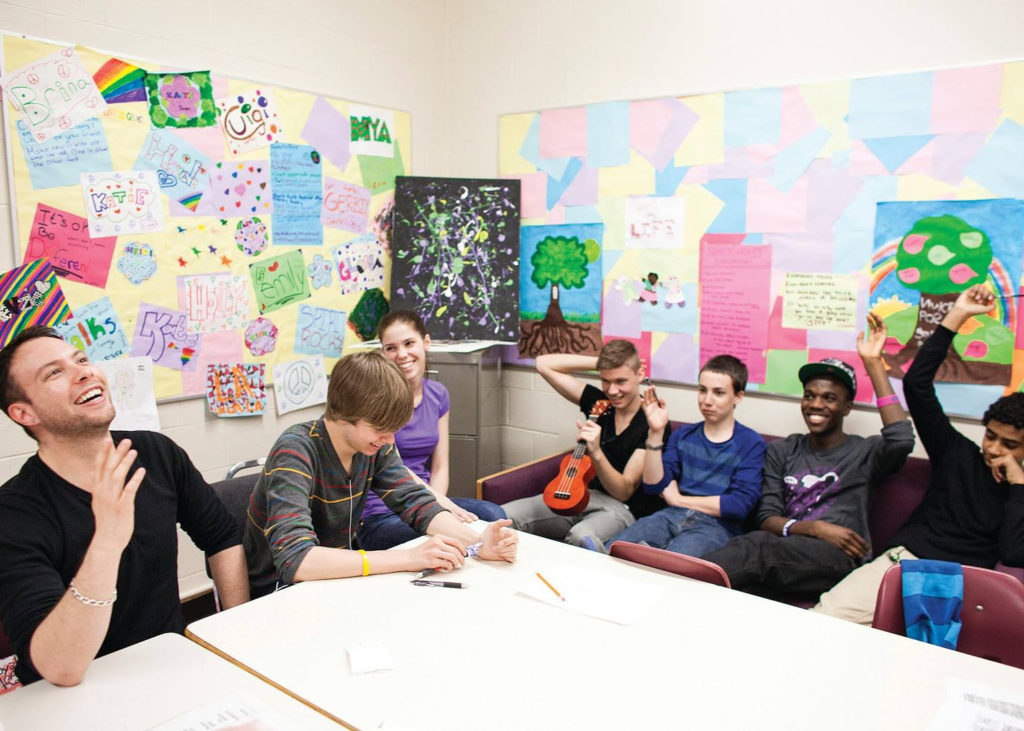A facilitator and youth during a WiseGuyz session