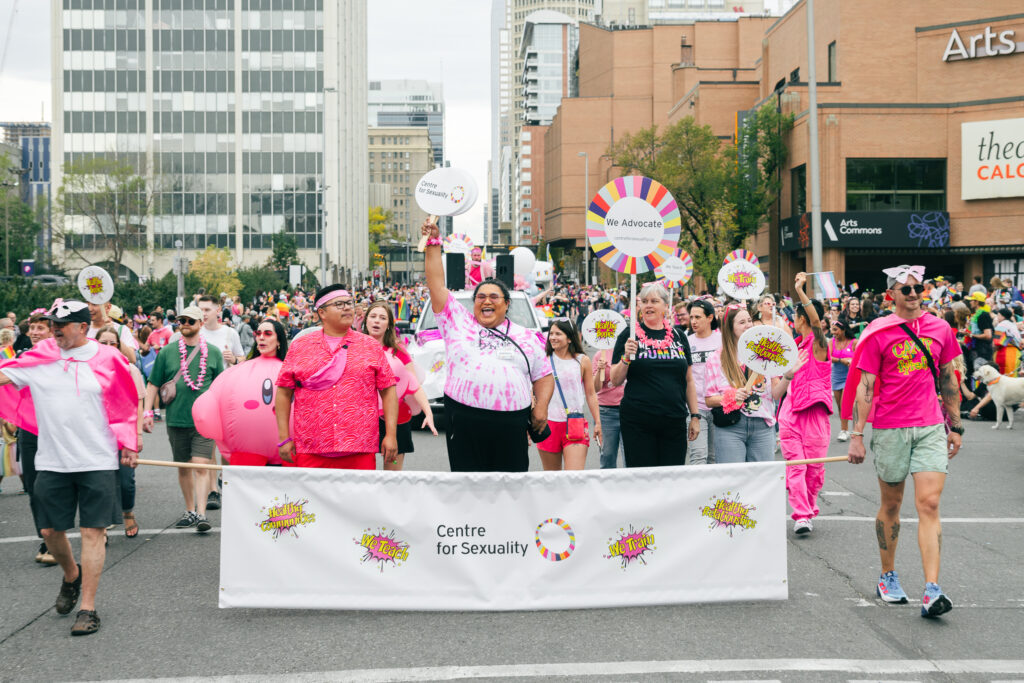 A group of people marching in the Calgary Pride parade.