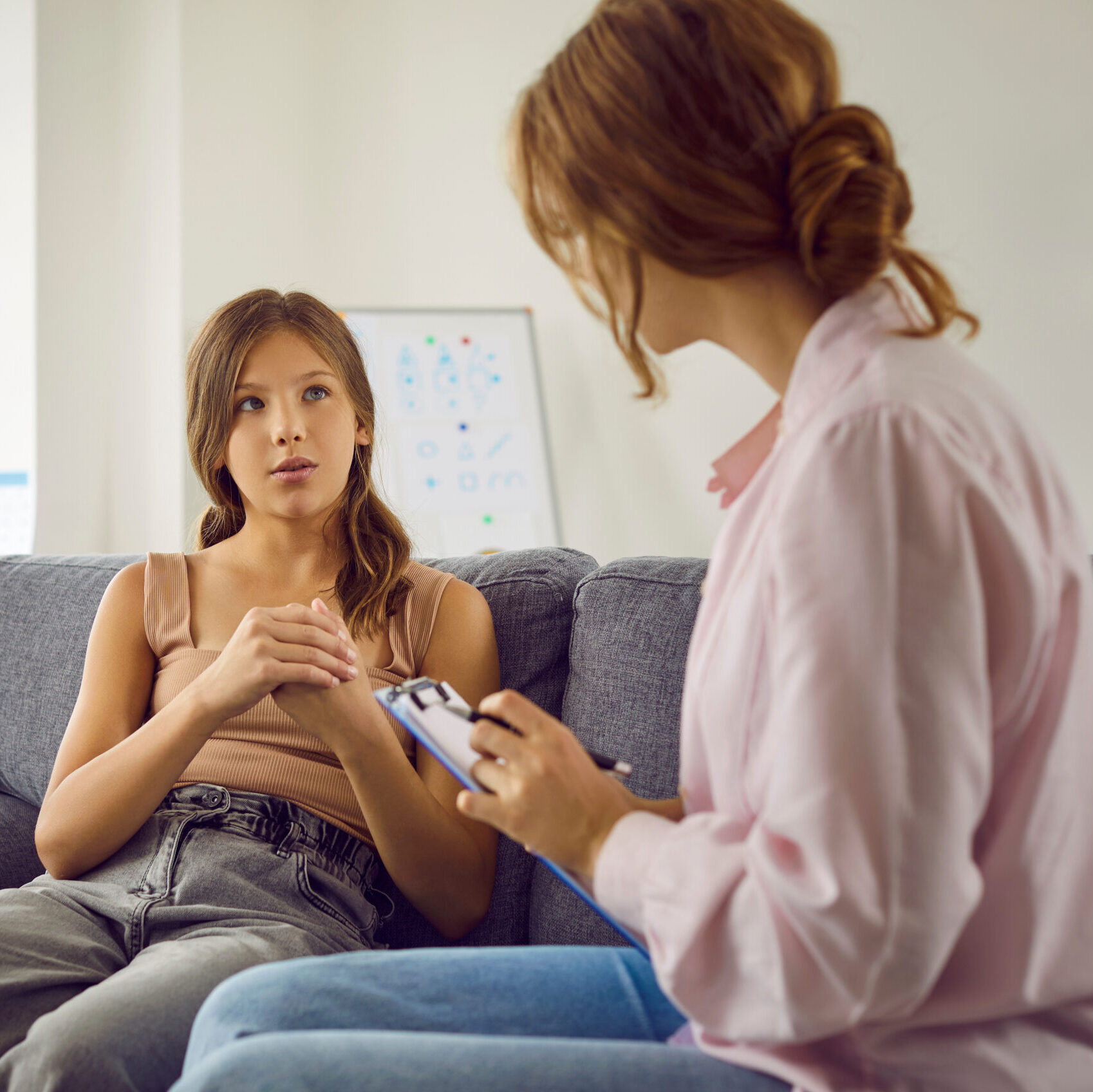 Professional therapist working with an adolescent girl.