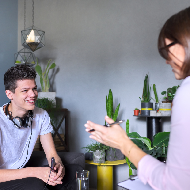 A teenager and an adult having a conversation as part of a one-on-one counselling session.